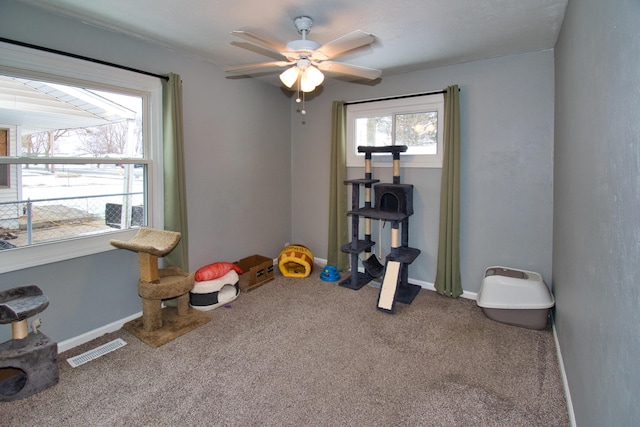 game room with carpet floors, baseboards, visible vents, and ceiling fan