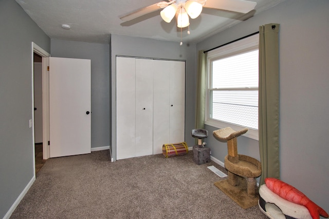 carpeted bedroom with baseboards, visible vents, ceiling fan, and a closet