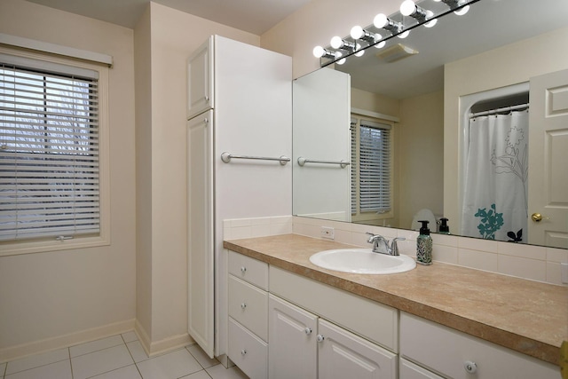 full bathroom featuring tile patterned flooring, vanity, and baseboards