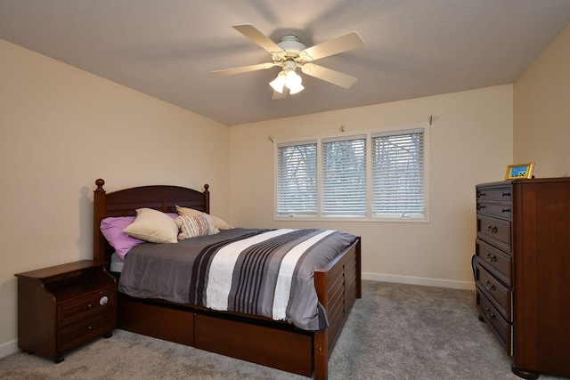 carpeted bedroom featuring a ceiling fan and baseboards