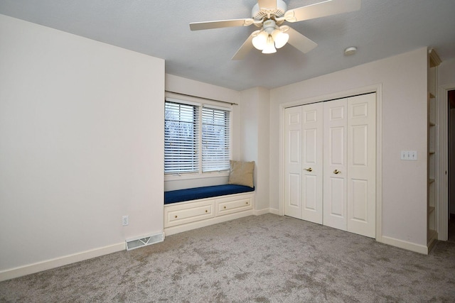 unfurnished bedroom featuring carpet floors, a closet, visible vents, and baseboards