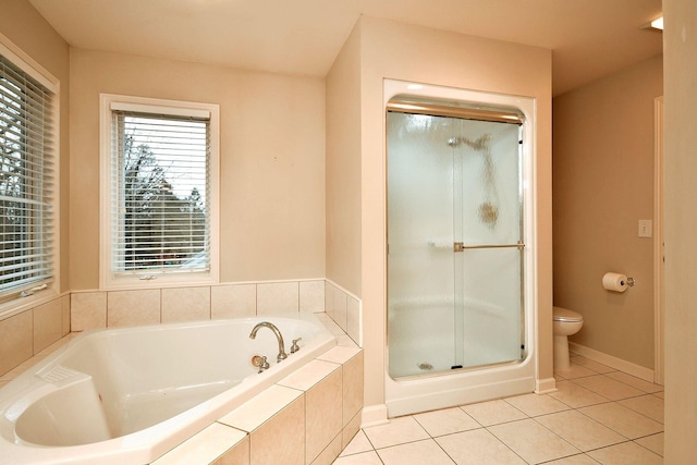 bathroom with tile patterned flooring, a shower stall, toilet, and a bath