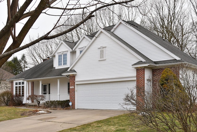 view of front of property featuring a garage, concrete driveway, roof with shingles, a porch, and brick siding