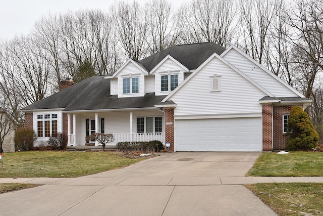 traditional home with covered porch, a garage, brick siding, driveway, and a front lawn