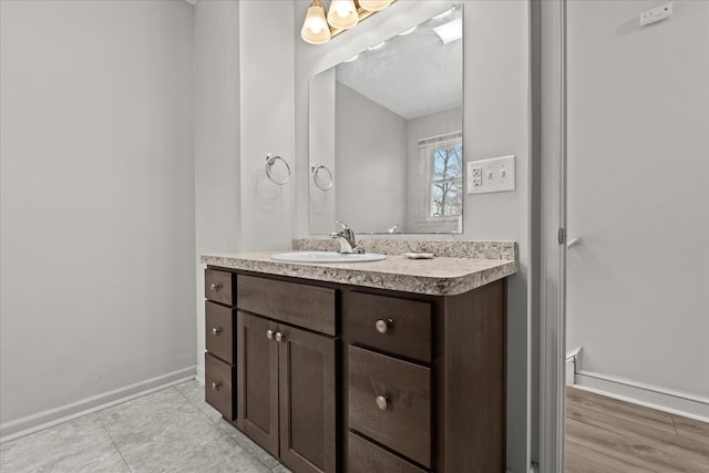 bathroom featuring tile patterned floors, vanity, and baseboards