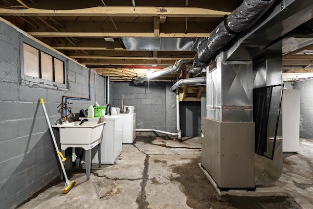 unfinished basement featuring heating unit and separate washer and dryer