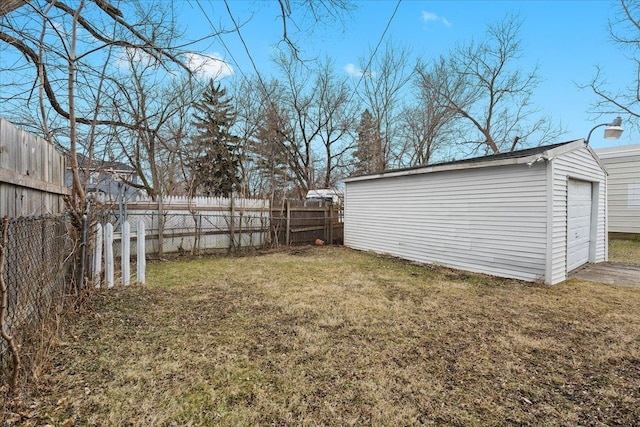 view of yard with an outbuilding and fence