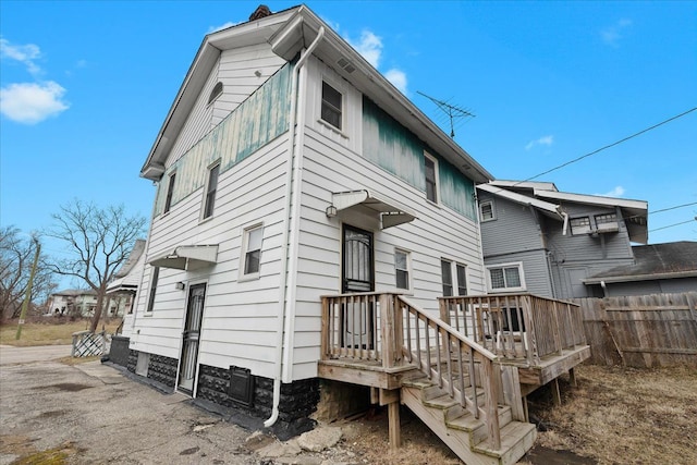 rear view of property with fence