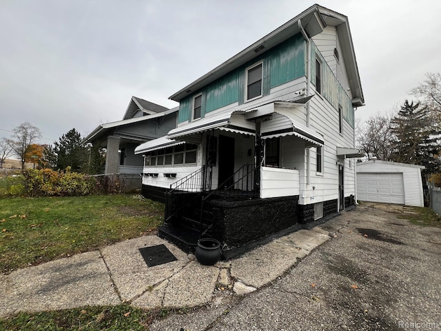 164 E Hamilton Ave, Flint, MI 48505 - view of front of property featuring an outbuilding, a front yard, and asphalt driveway