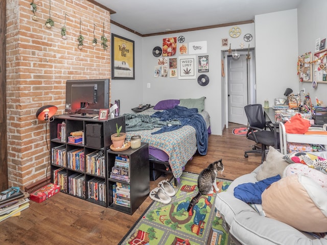 bedroom featuring wood finished floors and crown molding