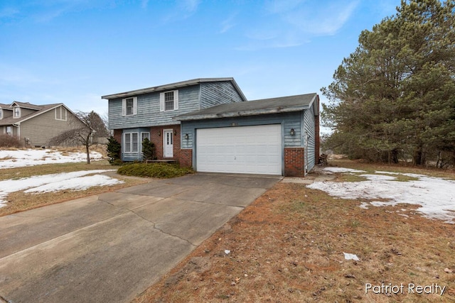 traditional home with a garage, concrete driveway, and brick siding