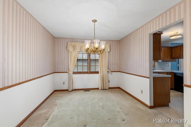 unfurnished dining area featuring a textured ceiling, a notable chandelier, light colored carpet, baseboards, and wallpapered walls