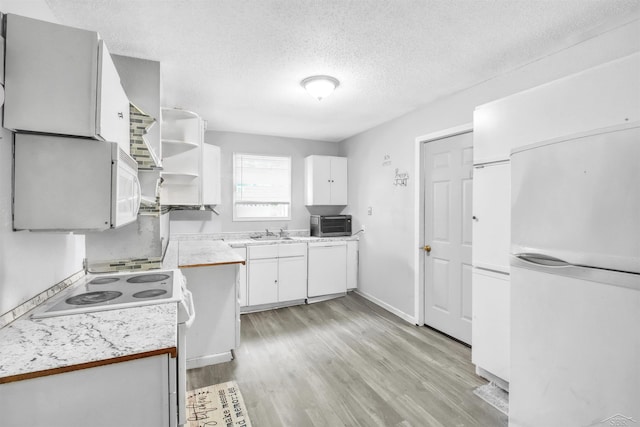 kitchen with open shelves, light countertops, light wood-style flooring, white cabinetry, and white appliances