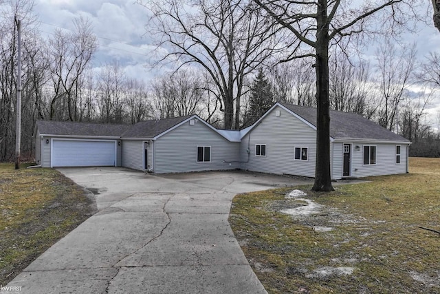 single story home featuring a shingled roof, driveway, and an attached garage