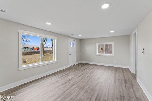 interior space with recessed lighting, wood finished floors, visible vents, and baseboards