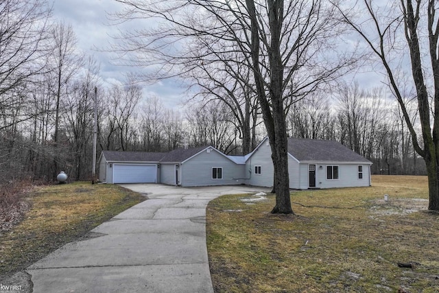 view of front of property featuring a garage, a front yard, and a shingled roof