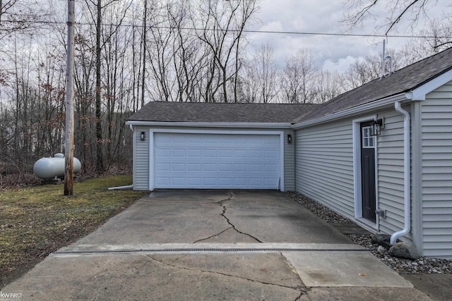 garage featuring concrete driveway