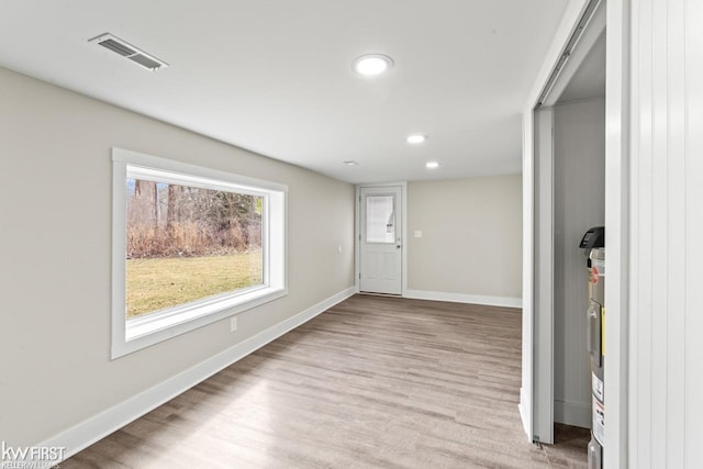 interior space with baseboards, visible vents, wood finished floors, and recessed lighting