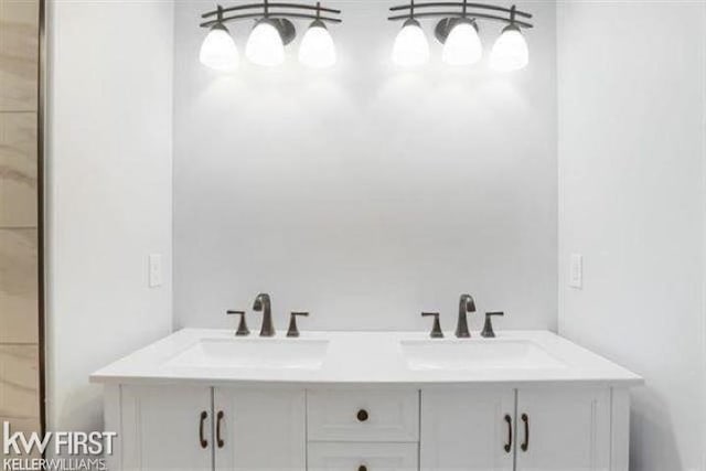 full bath featuring double vanity and a sink