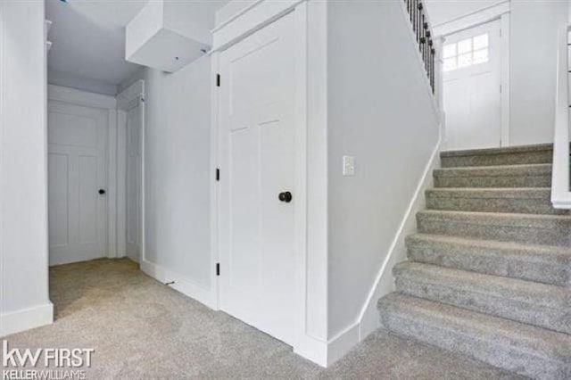 staircase with carpet flooring and baseboards