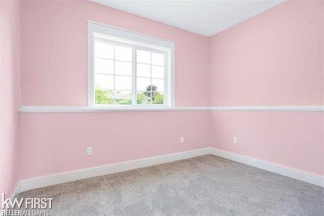 spare room with carpet and baseboards