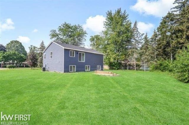 rear view of house with a yard