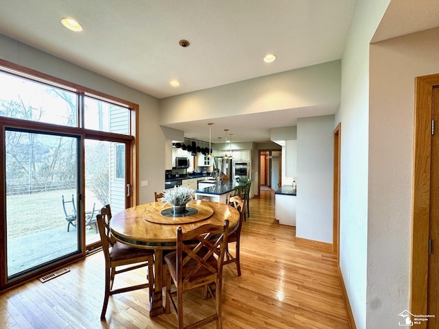 dining space with light wood finished floors, baseboards, visible vents, and recessed lighting