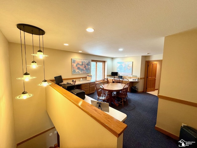 bar with built in desk, dark colored carpet, recessed lighting, a textured ceiling, and baseboards