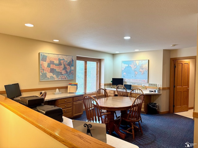 dining room with dark colored carpet, built in study area, and recessed lighting