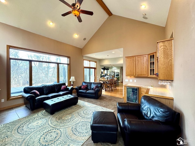 living room with light tile patterned floors, high vaulted ceiling, wine cooler, recessed lighting, and beam ceiling