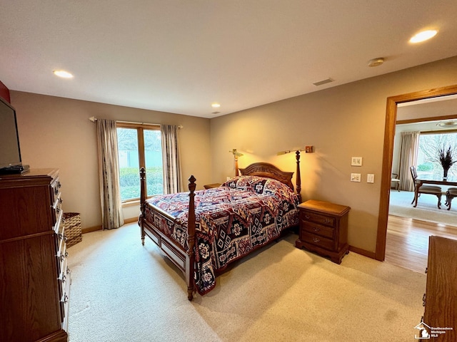 bedroom featuring light carpet, recessed lighting, visible vents, and baseboards