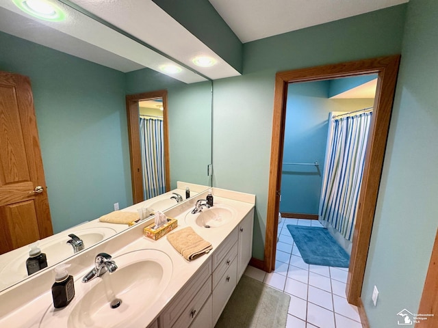 bathroom with double vanity, tile patterned flooring, and a sink