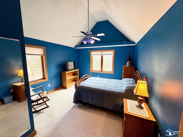 carpeted bedroom with multiple windows, vaulted ceiling, baseboards, and ceiling fan