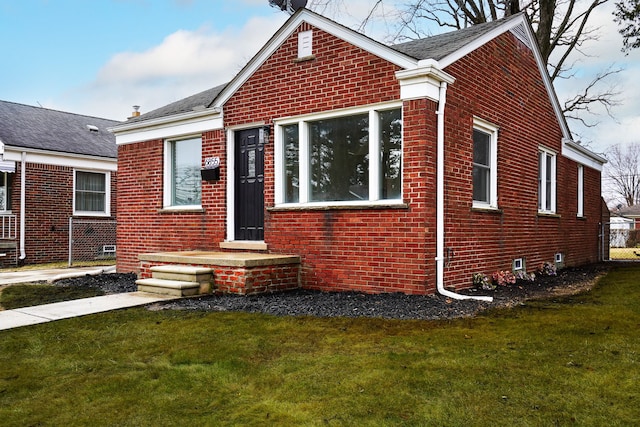 view of front facade featuring a front lawn and brick siding