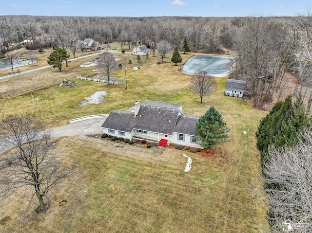 birds eye view of property with a view of trees