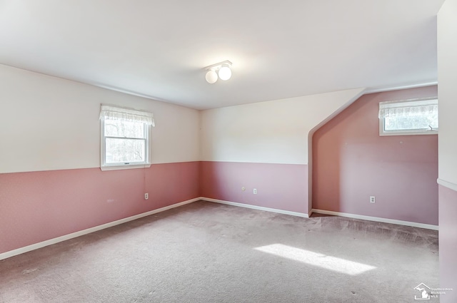 additional living space featuring carpet flooring and baseboards