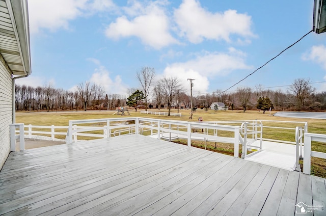 wooden deck featuring a yard