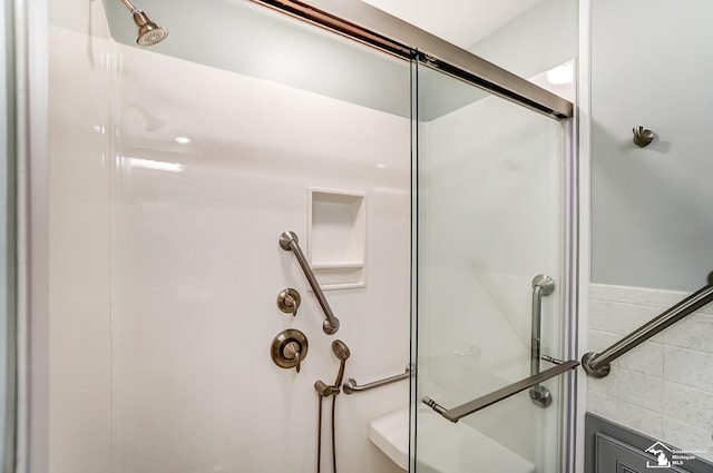 full bath with an enclosed shower and tile walls