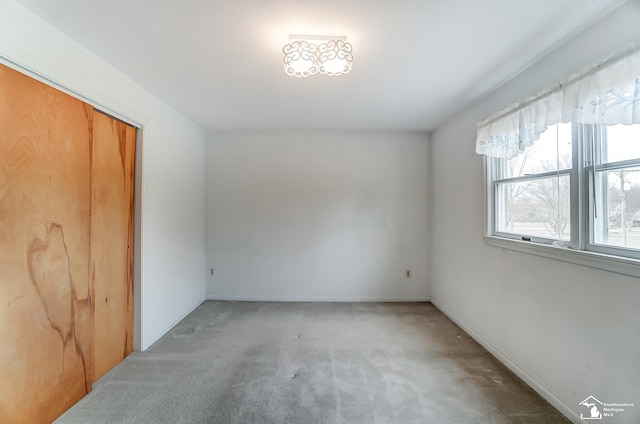 unfurnished room featuring carpet flooring