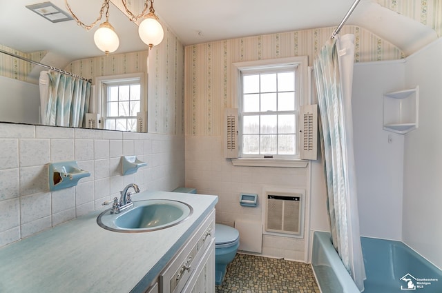 bathroom with wallpapered walls, visible vents, wainscoting, toilet, and heating unit