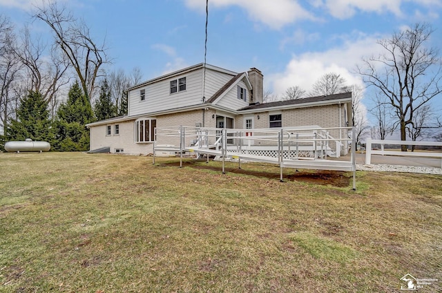 back of house featuring a wooden deck, a chimney, fence, a yard, and brick siding