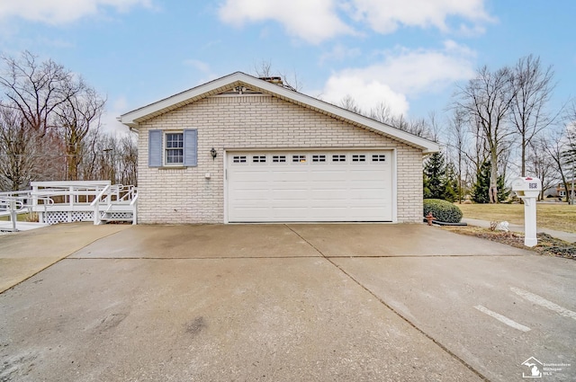 exterior space featuring a detached garage and brick siding