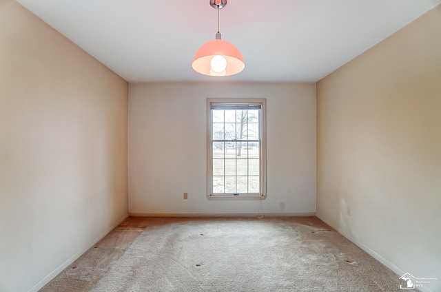 spare room with carpet and baseboards