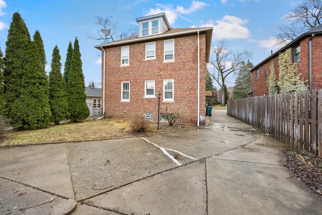 2412 Cornell St, Dearborn, MI 48124 - rear view of house featuring fence and brick siding