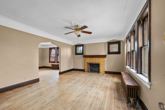 2412 Cornell St, Dearborn, MI 48124 - unfurnished living room with hardwood / wood-style flooring, ceiling fan, baseboards, and a tiled fireplace