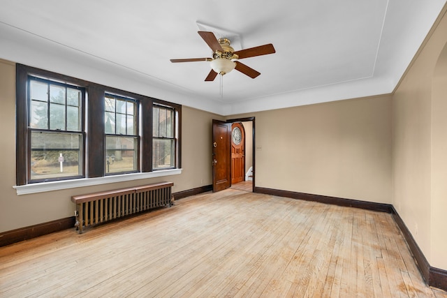2412 Cornell St, Dearborn, MI 48124 - spare room with radiator, wood-type flooring, baseboards, and a ceiling fan