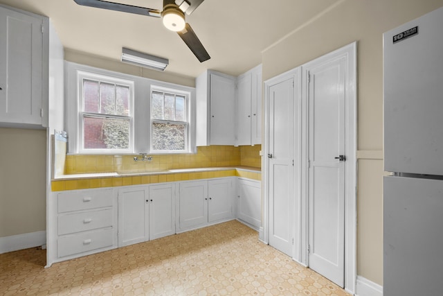2412 Cornell St, Dearborn, MI 48124 - kitchen featuring tasteful backsplash, a ceiling fan, light countertops, light floors, and a sink