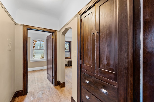 2412 Cornell St, Dearborn, MI 48124 - hall featuring arched walkways, baseboards, light wood-style flooring, and radiator heating unit
