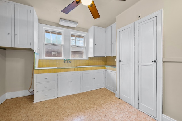 2412 Cornell St, Dearborn, MI 48124 - kitchen featuring white cabinetry, a ceiling fan, light countertops, light floors, and tasteful backsplash