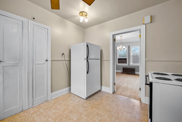 2412 Cornell St, Dearborn, MI 48124 - kitchen with light floors, radiator heating unit, white appliances, baseboards, and ceiling fan with notable chandelier
